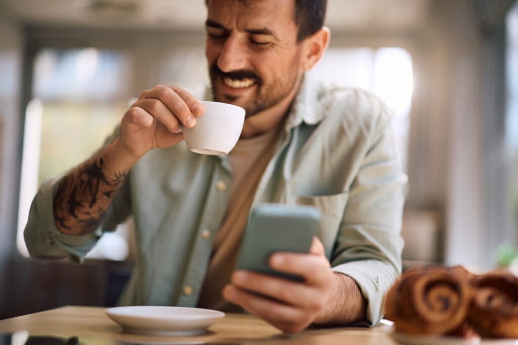 close-up-of-happy-man-drinking-coffee-in-a-cafeteria--1024x682 Do Terroir à Xícara de Café: Os Caminhos que Definem a Bebida Mais Amada do Brasil