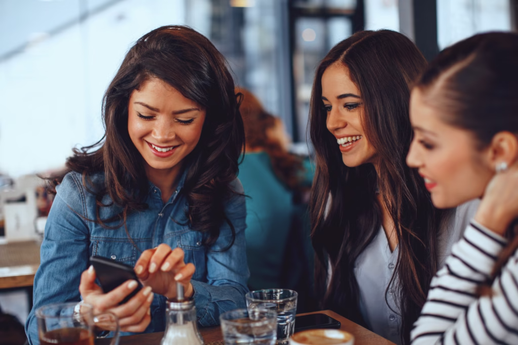 three-young-women-having-fun-at-a-coffee-shop-1024x682 O Café e sua Função Social: Como uma Bebida Uniu Pessoas e Transformou Sociedades